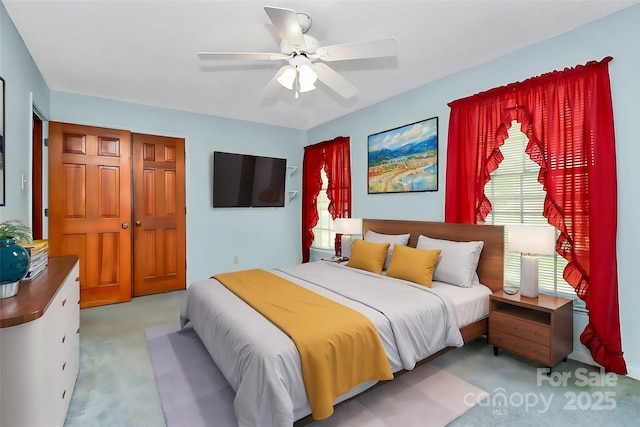 carpeted bedroom featuring ceiling fan