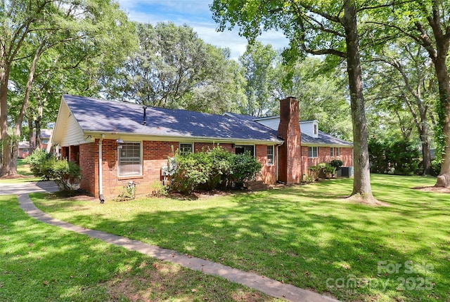 view of front of property with cooling unit and a front lawn