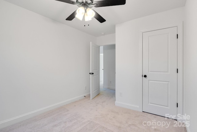 unfurnished bedroom featuring ceiling fan and light carpet