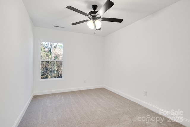 spare room with carpet and ceiling fan