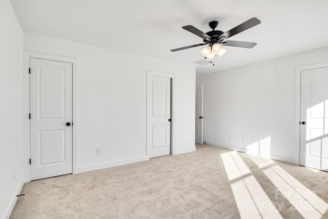 unfurnished bedroom featuring ceiling fan and light colored carpet