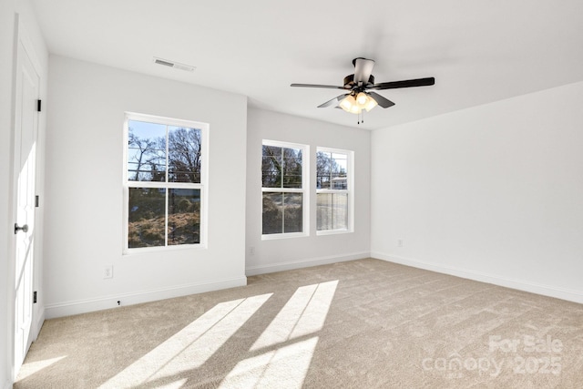 carpeted spare room featuring ceiling fan