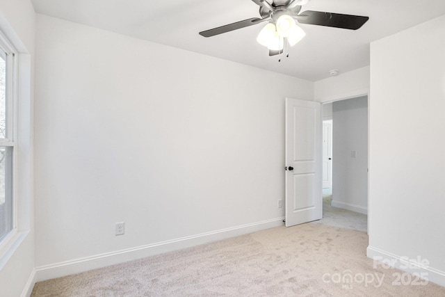 spare room with light carpet and ceiling fan