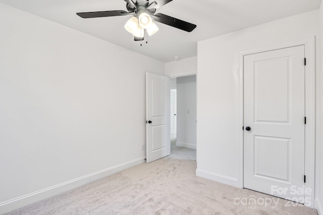 unfurnished bedroom featuring ceiling fan and light colored carpet