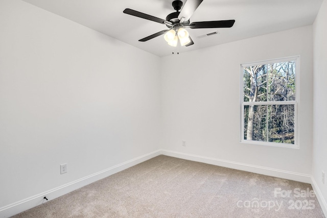 spare room featuring carpet floors and ceiling fan