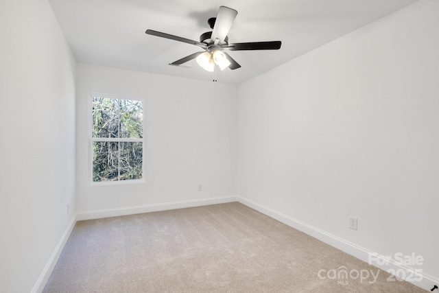 carpeted empty room featuring ceiling fan