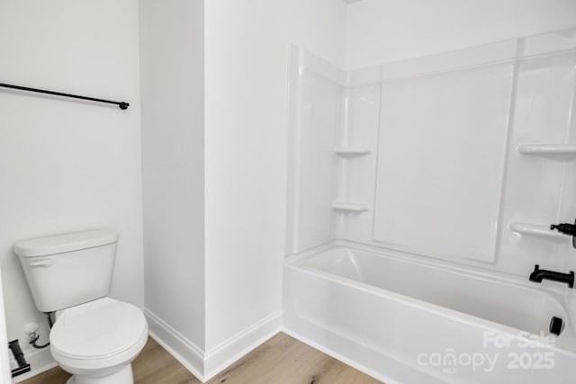 bathroom featuring toilet, shower / tub combination, and hardwood / wood-style floors