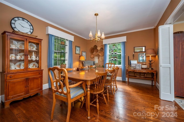 dining area with dark wood-type flooring, crown molding, and a chandelier