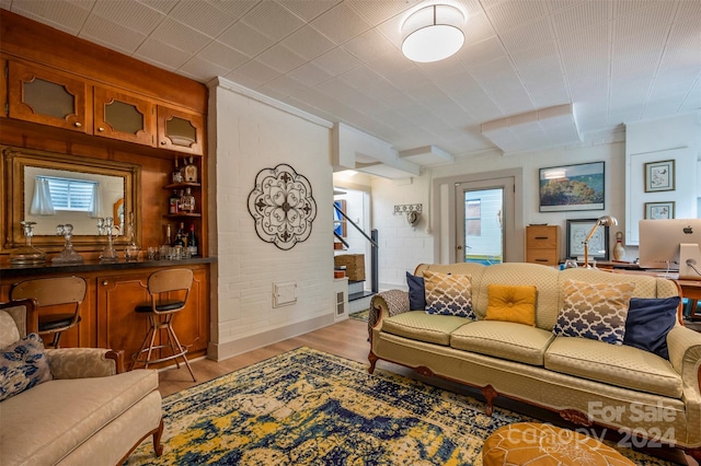 living room featuring light hardwood / wood-style flooring and indoor bar