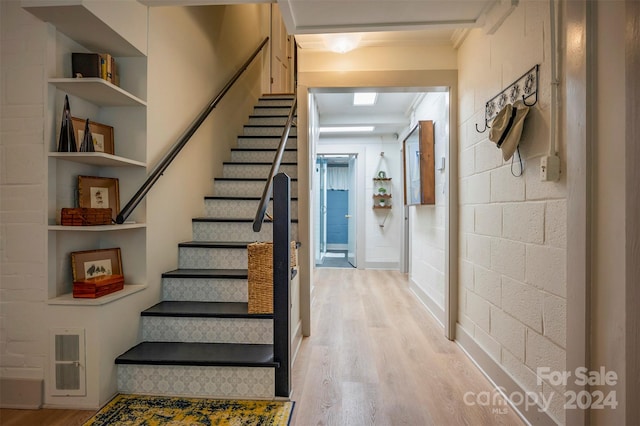 stairs featuring hardwood / wood-style floors