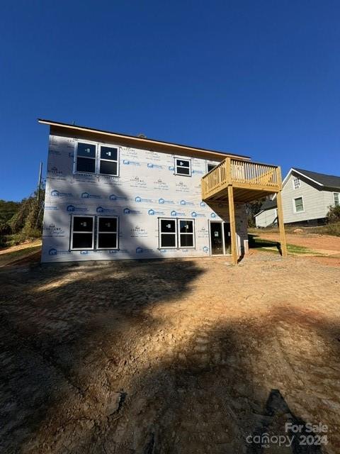 rear view of property featuring a deck