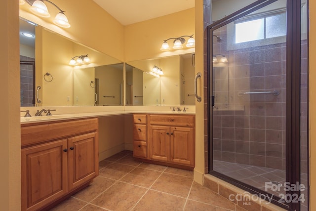 bathroom with walk in shower, tile patterned floors, and vanity