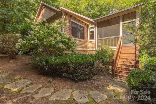 view of side of home featuring a sunroom