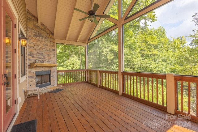 deck with ceiling fan and a fireplace