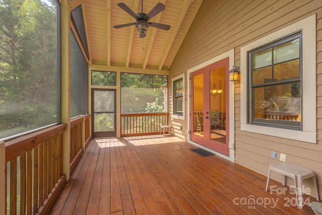 unfurnished sunroom featuring vaulted ceiling with beams, wooden ceiling, and ceiling fan