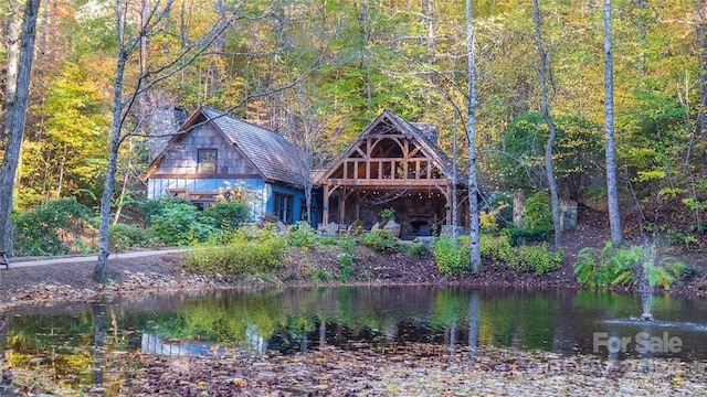 rear view of house featuring a water view