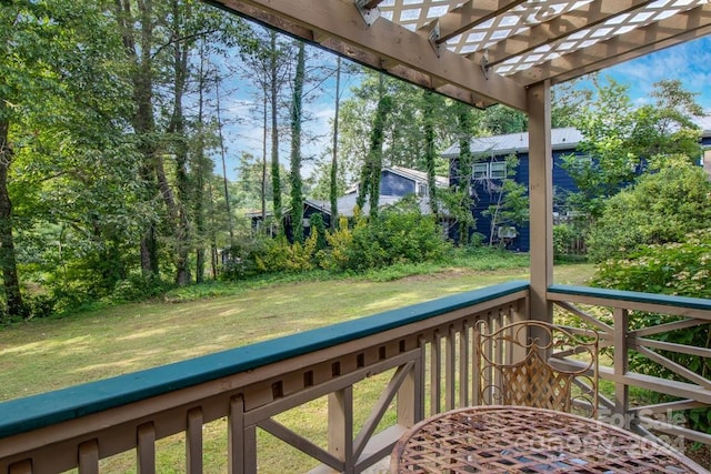 wooden terrace with a pergola and a lawn