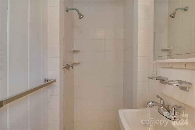 bathroom with a tile shower and sink