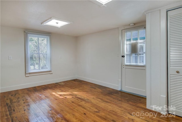 spare room featuring hardwood / wood-style floors