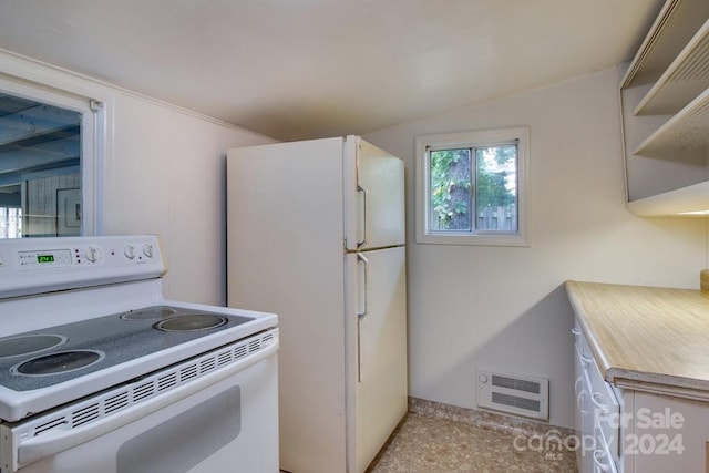 kitchen featuring vaulted ceiling, white appliances, and heating unit