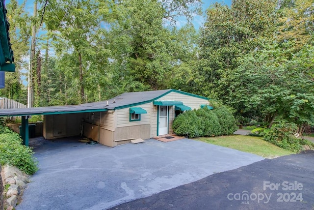 view of property exterior with a carport