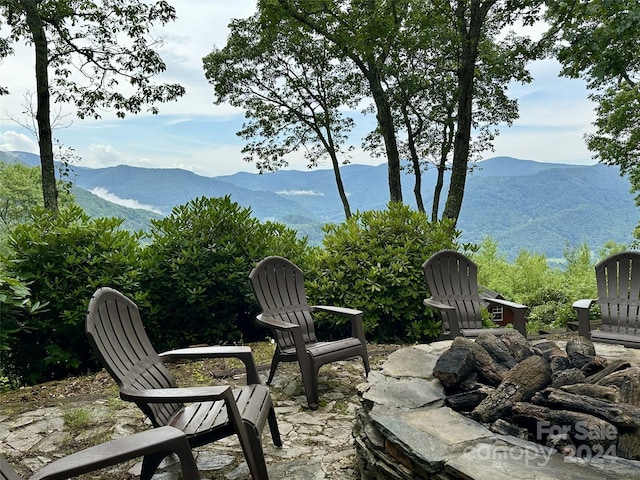 view of patio with a mountain view and a fire pit