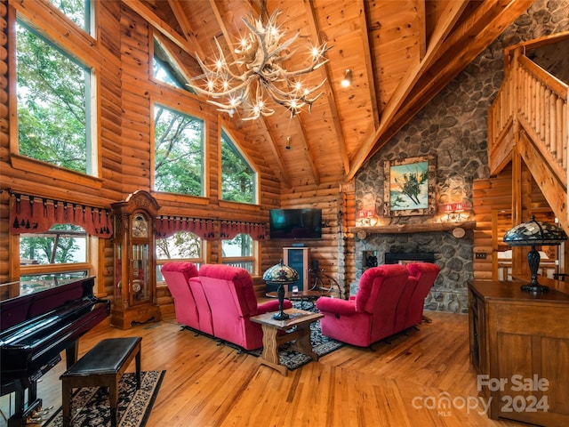 living room with hardwood / wood-style floors, high vaulted ceiling, and plenty of natural light