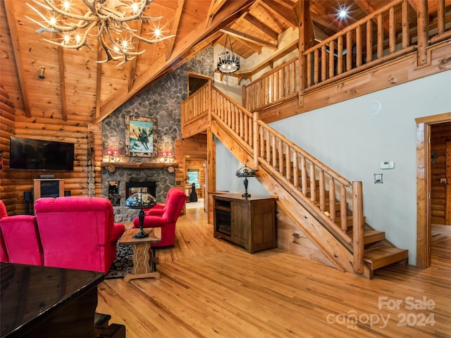 living room featuring hardwood / wood-style floors, a notable chandelier, and wooden ceiling