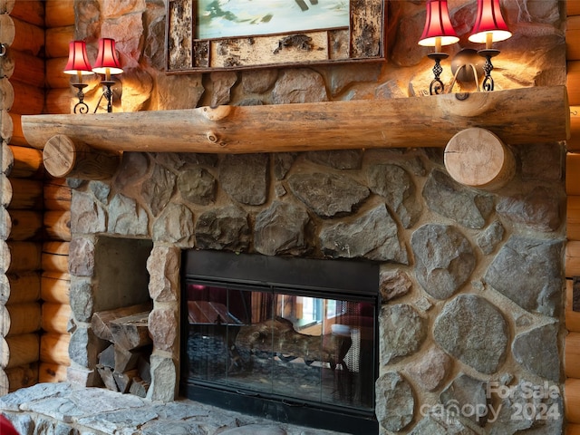 room details featuring a stone fireplace and rustic walls