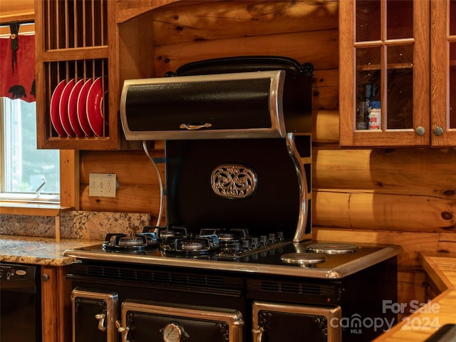 kitchen with light stone countertops and black dishwasher