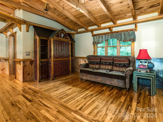 living room with wood-type flooring, vaulted ceiling with beams, wood walls, and wood ceiling