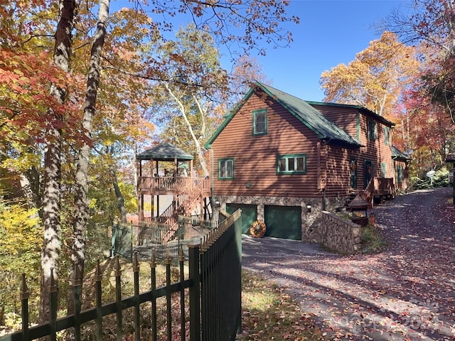 exterior space with a garage and a wooden deck