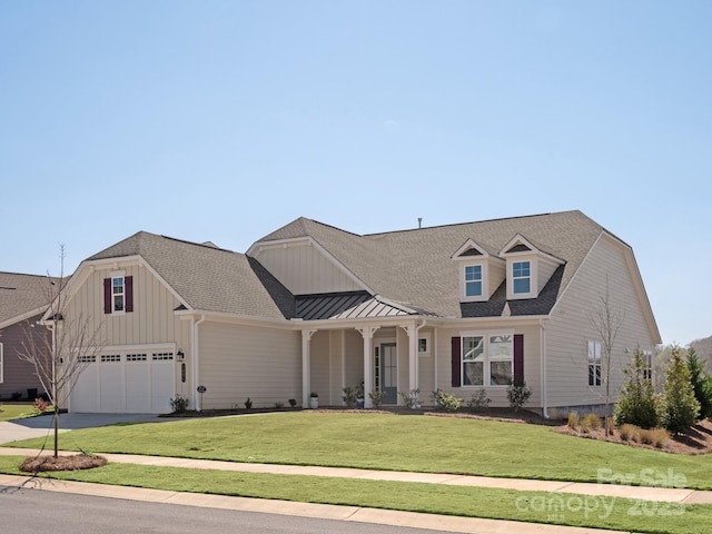 view of front of home with a front yard and a garage