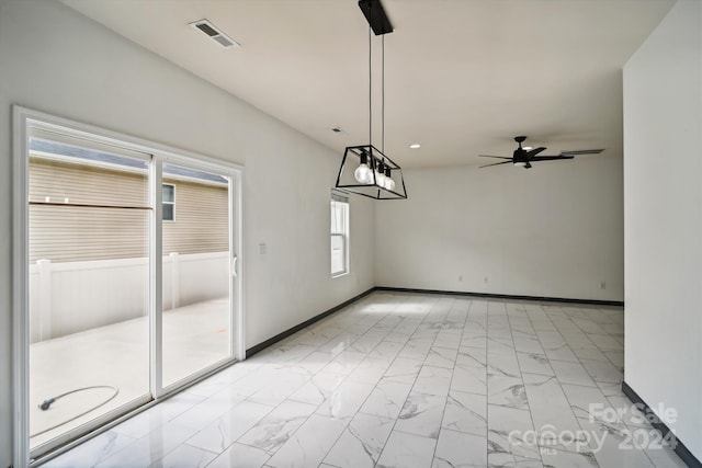 unfurnished dining area with ceiling fan and light tile patterned floors