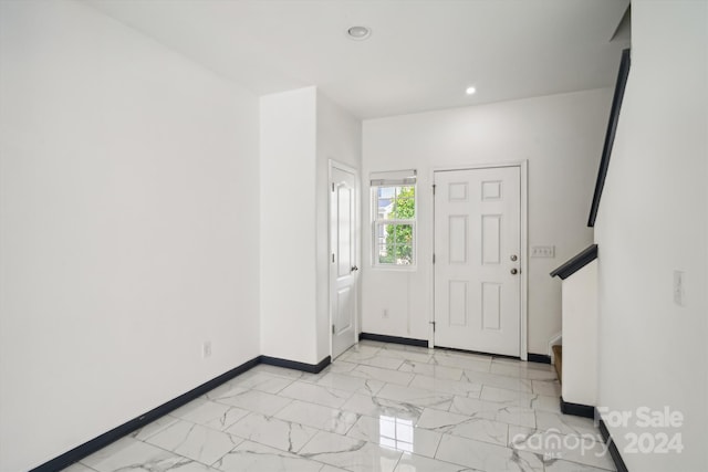 foyer entrance with light tile patterned floors