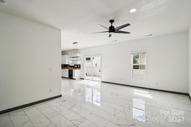 unfurnished living room featuring ceiling fan and light tile patterned floors