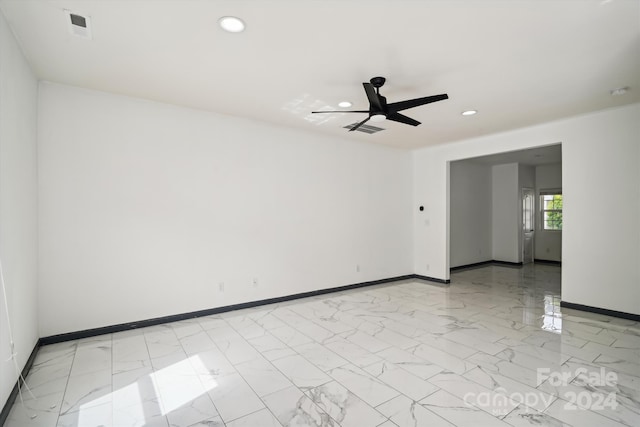 tiled spare room with ceiling fan