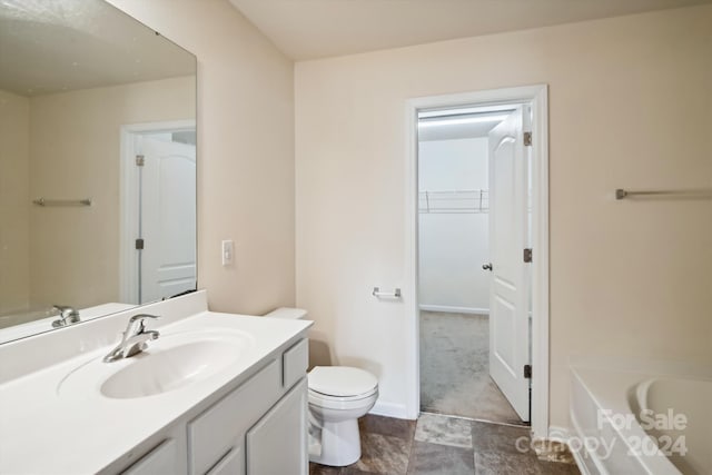 bathroom featuring vanity, tile patterned flooring, and toilet