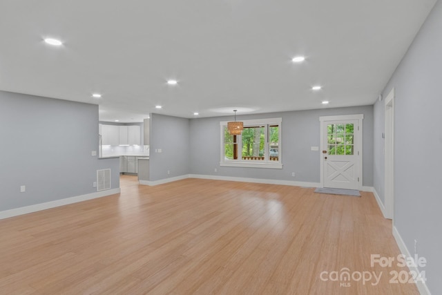 unfurnished living room with light hardwood / wood-style floors