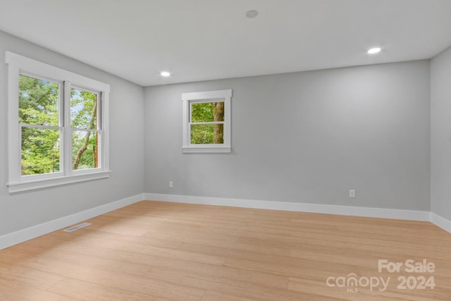 spare room featuring light wood-type flooring