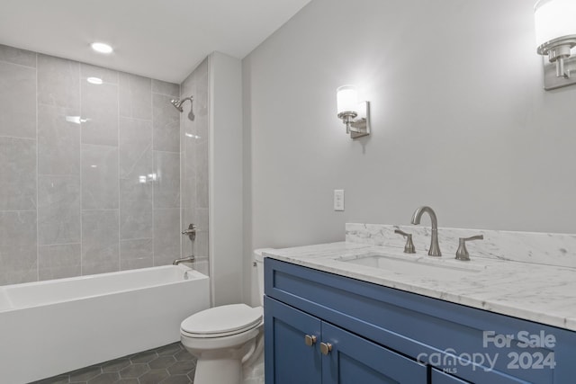 full bathroom featuring vanity, toilet, tiled shower / bath combo, and tile patterned flooring