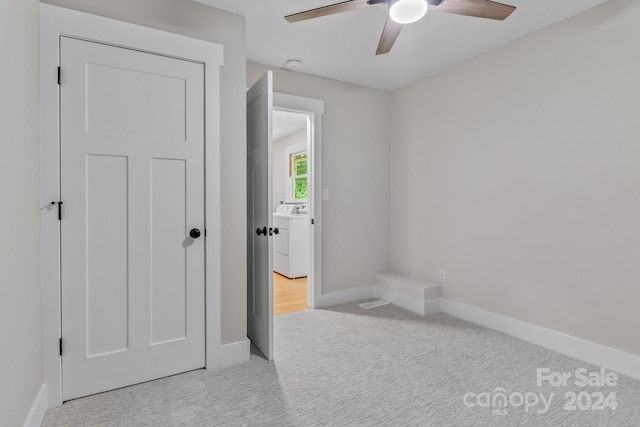 interior space featuring light carpet, washer / dryer, a closet, and ceiling fan