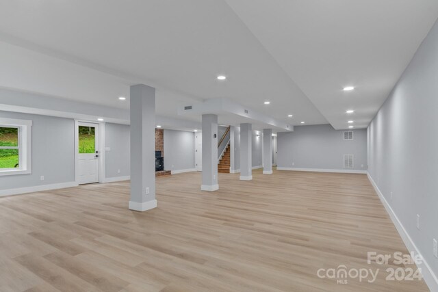 basement with light hardwood / wood-style flooring