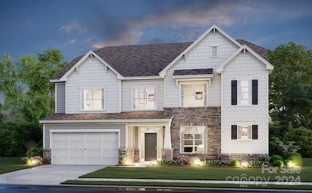 view of front of house with driveway, a shingled roof, stone siding, an attached garage, and a yard