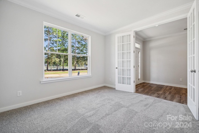 carpeted empty room with french doors and crown molding