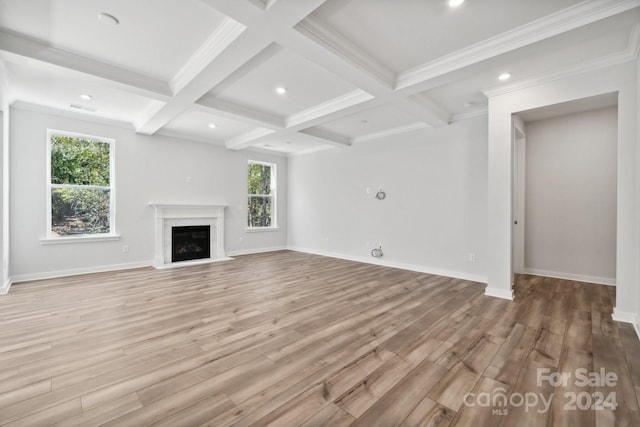 unfurnished living room featuring hardwood / wood-style floors, beam ceiling, and coffered ceiling