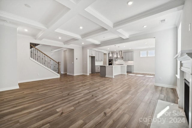 unfurnished living room featuring dark hardwood / wood-style flooring, coffered ceiling, ornamental molding, and beam ceiling