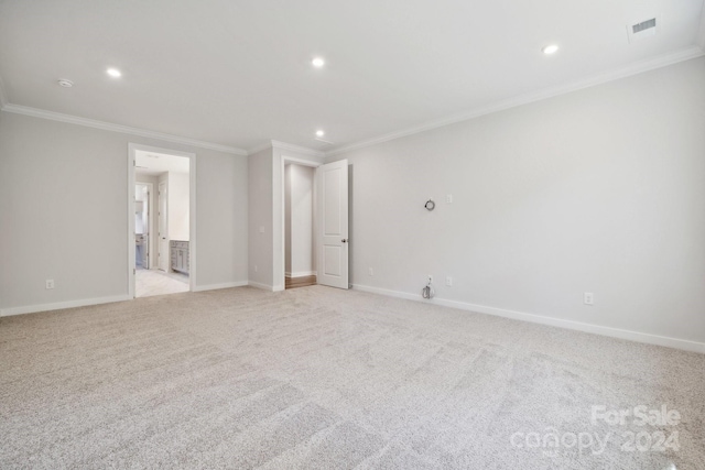 carpeted spare room featuring ornamental molding