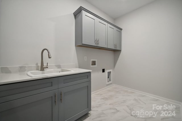 washroom featuring cabinets, hookup for an electric dryer, hookup for a washing machine, and sink