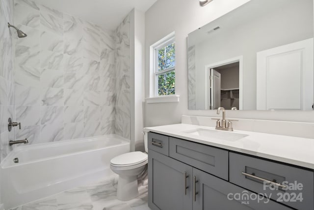 full bathroom with vanity, toilet, and tiled shower / bath combo